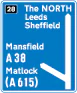 Motorway junction, displaying route number and destination reached as well as destination reached by remaining on the motorway