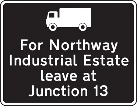 Exit from a motorway junction ahead that should be used for a destination along the route advised for goods vehicles