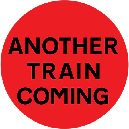 Another train or tramcar may be about to pass over the level crossing